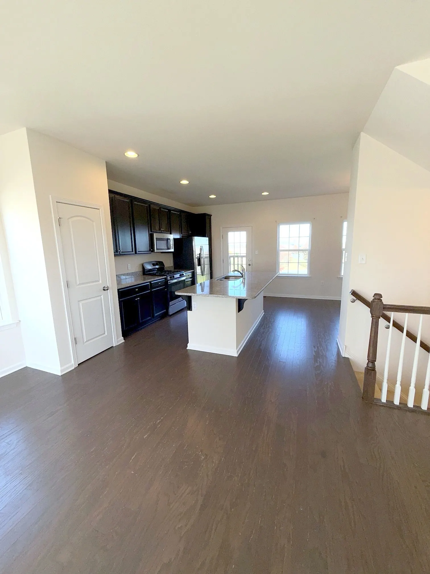 Kitchen with granite island and stainless appliances