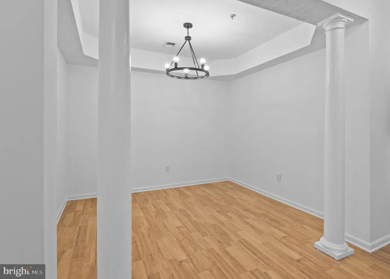 Dining area with columns and chandelier