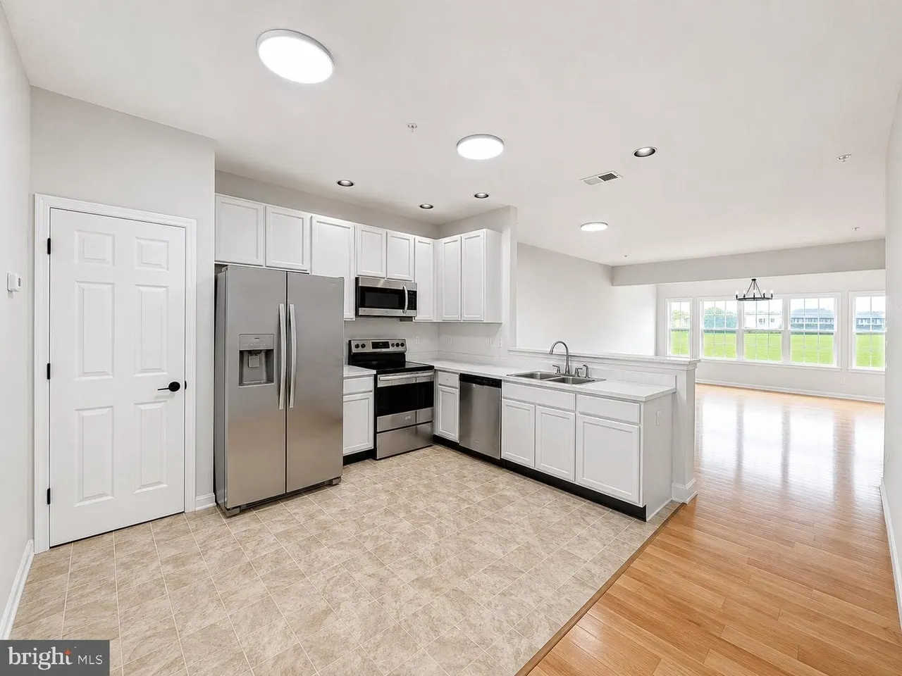 Kitchen with stainless appliances, open to the living area