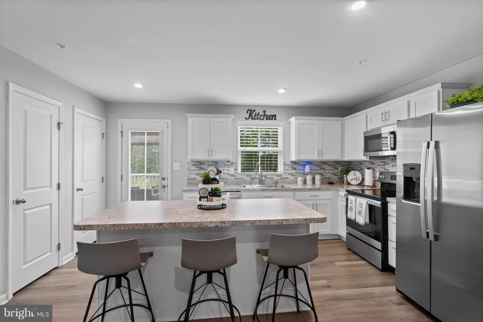 Kitchen with large island and stainless appliances