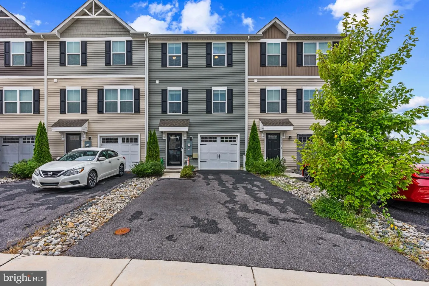 Front of the townhome with driveway and garage